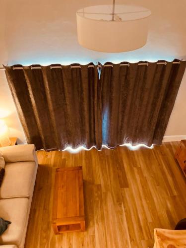a black curtain in a living room with a couch at Teach Máire, Downings in Downings