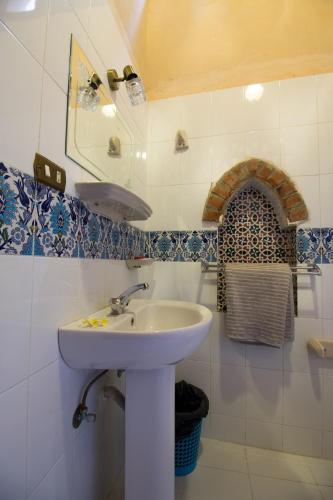 a bathroom with a sink and a mirror at Villa Rosamund in Luxor