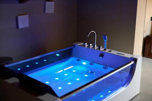 a large blue tub with a sink in a room at Rooms Don Alfonso in Parma
