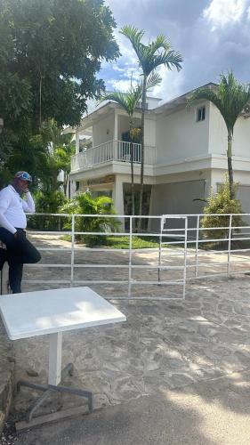 a man sitting on a bench in front of a building at the million view room habitacion en resort solo adultos in La Laguna