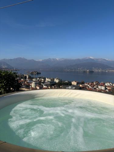 a hot tub with a view of the water at Panorama Loft Apartments in Stresa