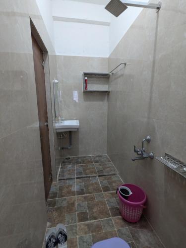 a bathroom with a shower and a toilet and a sink at Nomad's Nest in Hospet