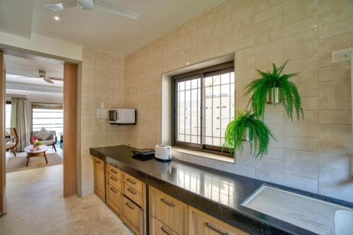 a kitchen with a counter top and a window at Villa Savaaya Assagao Goa in Assagao
