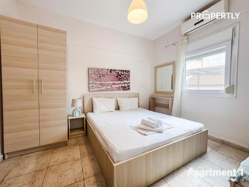 a bedroom with a large bed and a window at SeaYa Beach Retreat - Private Parking in Nea Kalikratia