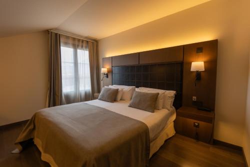 a hotel room with a bed and a window at La Piconera Hotel & Spa in Ribadesella
