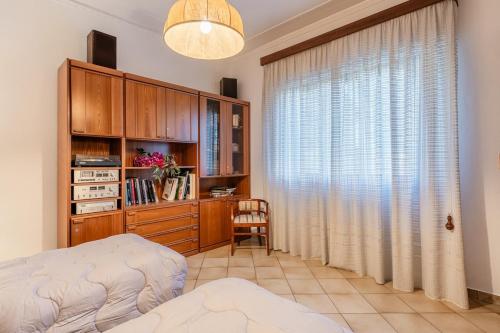 a bedroom with a bed and a desk and a window at La Casina Di Loriana in Altopascio