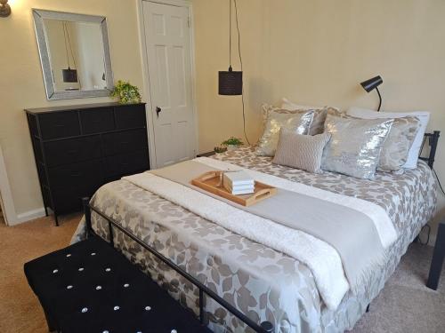 a bedroom with a large bed with a table on it at ShayBnB in Portsmouth