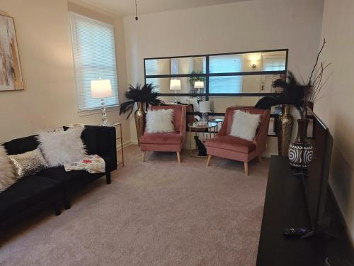 a living room with a couch and two chairs at ShayBnB in Portsmouth