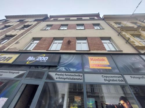a tall building with signs on the side of it at Apartment ČSA #5 in the Historic Center Hradec Králové in Hradec Králové