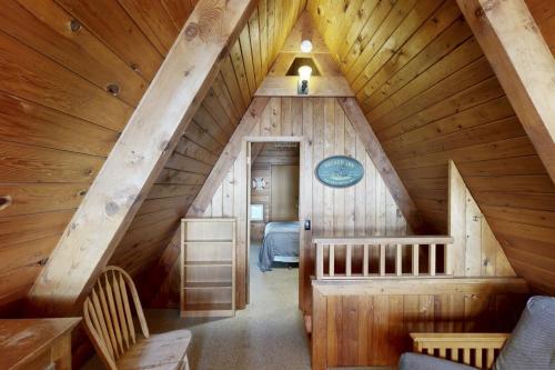 a attic room with a bed and a staircase at Pirate's Paradise in Lincoln City