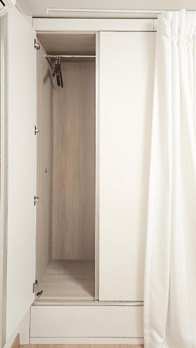 a mirror in a white room with curtains at Lucky Vicky House in Seoul