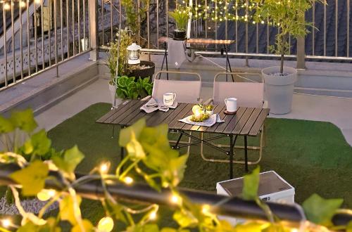 a patio with a table and chairs and plants at Lucky Vicky House in Seoul