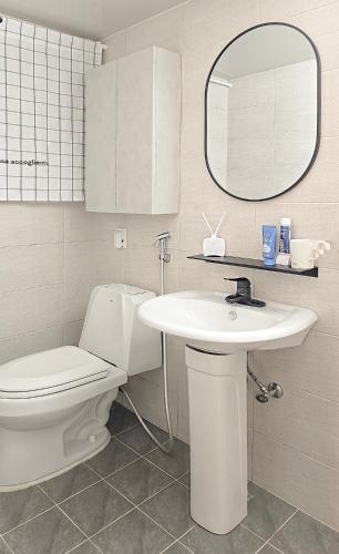 a bathroom with a toilet and a sink and a mirror at Lucky Vicky House in Seoul