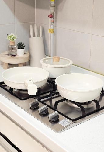 two bowls on top of a stove in a kitchen at Lucky Vicky House in Seoul