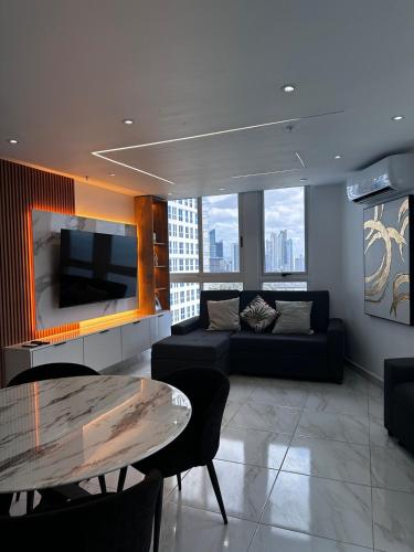 a living room with a couch and a table at A resort style apartment with ocean views with two bedrooms in Panama City