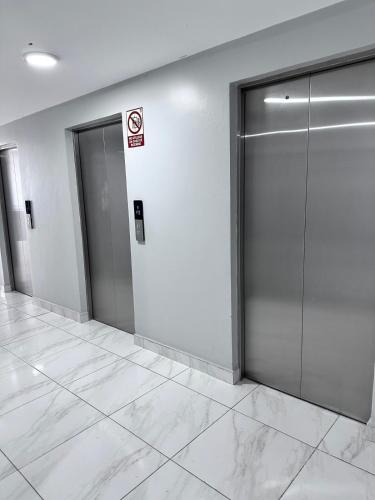 a hallway with two elevator doors in a building at A resort style apartment with ocean views with two bedrooms in Panama City
