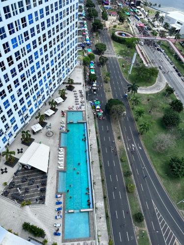 an overhead view of a swimming pool next to a building at A resort style apartment with ocean views with two bedrooms in Panama City