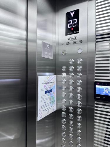 a metal elevator with a bunch of buttons on it at A resort style apartment with ocean views with two bedrooms in Panama City