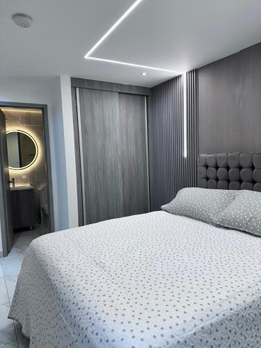 a bedroom with a large white bed in a room at A resort style apartment with ocean views with two bedrooms in Panama City
