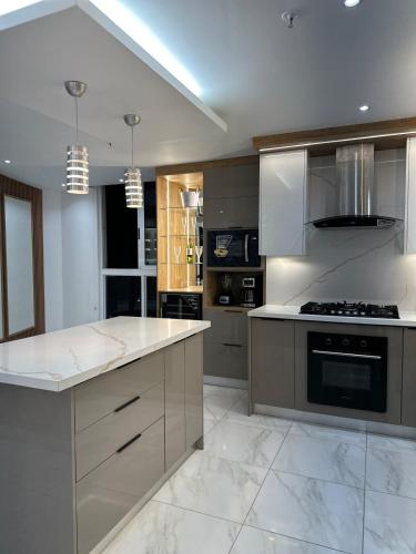 a large kitchen with white marble counter tops and appliances at A resort style apartment with ocean views with two bedrooms in Panama City