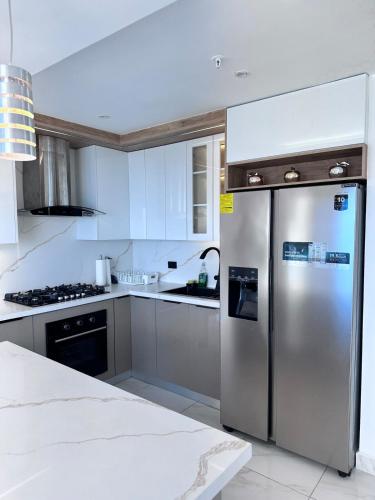a kitchen with a stainless steel refrigerator at A resort style apartment with ocean views with two bedrooms in Panama City