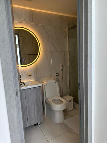 a bathroom with a toilet and a sink and a mirror at A resort style apartment with ocean views with two bedrooms in Panama City
