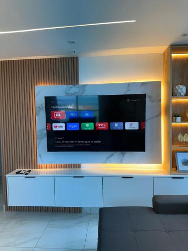 a large tv on a wall in a room at A resort style apartment with ocean views with two bedrooms in Panama City