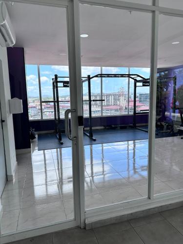 an open glass door with a view of a building at A resort style apartment with ocean views with two bedrooms in Panama City