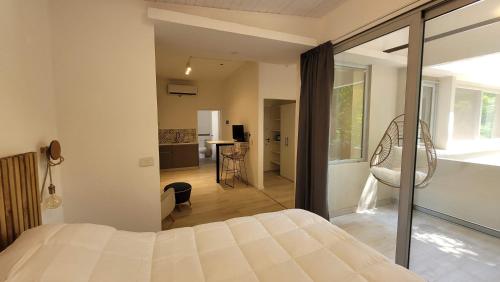 a bedroom with a bed and a living room at La Belle San Isidro Lofts in San Isidro