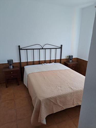 a bedroom with a bed and two nightstandumentsuments at Villa Encanto Chiclana in Novo Sancti Petri