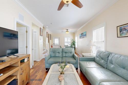 a living room with a couch and a flat screen tv at Hemingway Hideaway in Stock Island