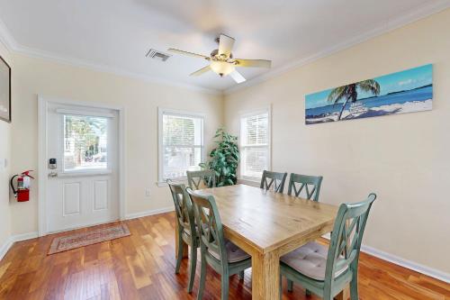 a dining room with a wooden table and chairs at Hemingway Hideaway in Stock Island