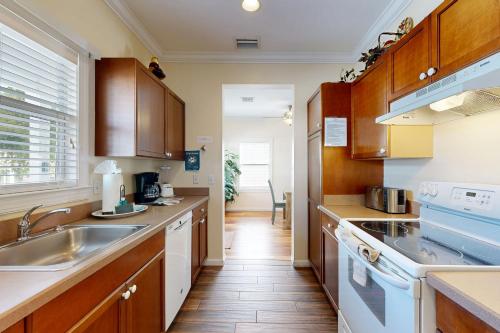 a kitchen with wooden cabinets and a sink at Hemingway Hideaway in Stock Island
