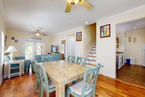 a dining room with a wooden table and chairs at Hemingway Hideaway in Stock Island