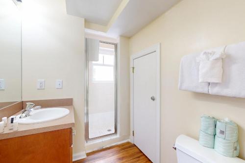 a bathroom with a sink and a mirror at Hemingway Hideaway in Stock Island