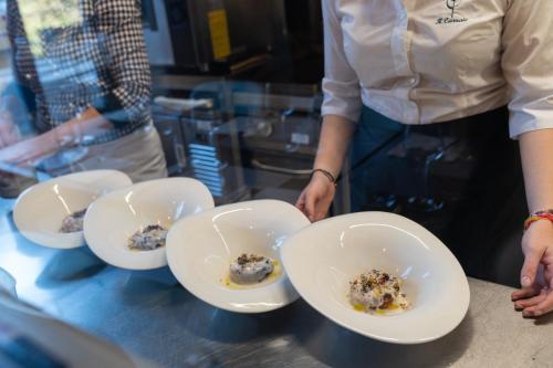 a person holding four bowls with food in them at Morelliana4Rooms in Scansano