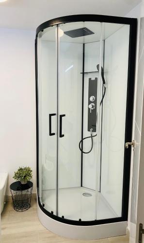 a shower with a glass door in a bathroom at Blue house 1ª linea playa in Torrevieja