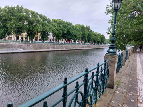 a street light next to a fence next to a river at Apartment ČSA #5 in the Historic Center Hradec Králové in Hradec Králové