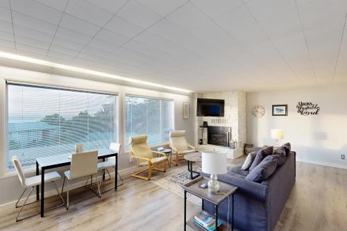 a living room with a couch and a table at Wycliff Beach Condo in Lincoln City