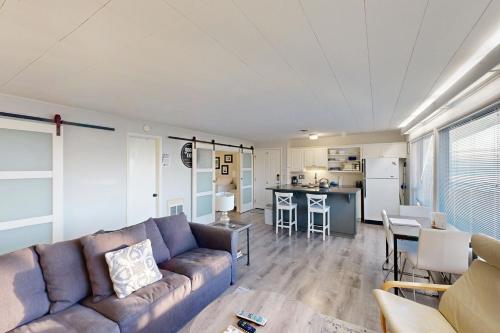 a living room with a couch and a kitchen at Cozy Ocean-View Condo Near Beach & Coastal Events in Lincoln City