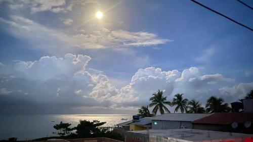 a view of the ocean and a cloudy sky at Casa Beira Mar in Santa Cruz Cabrália