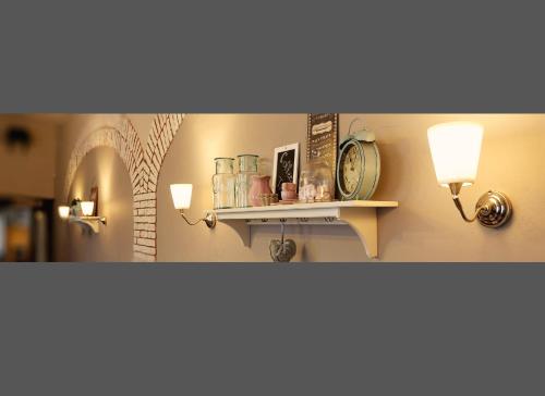a room with two lights and a shelf with jars at Antonio Old Town Residence in Prešov