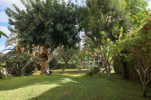 a park with trees and green grass and a field at Appartamenti DueC in Trapani
