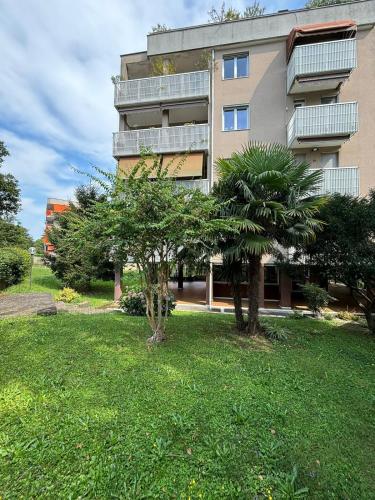 a building with two trees in front of it at Appartamento zona Rho Fiera in Arese