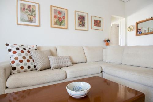 a living room with a couch and a coffee table at Varkiza Apartment in Varkiza
