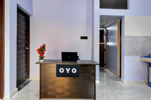 a reception desk with a laptop on top of it at Super Hotel O MNJ Mansion in Bhubaneshwar
