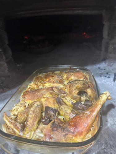 a glass dish of food with sausage and pasta at VILA DISHA in Tirana
