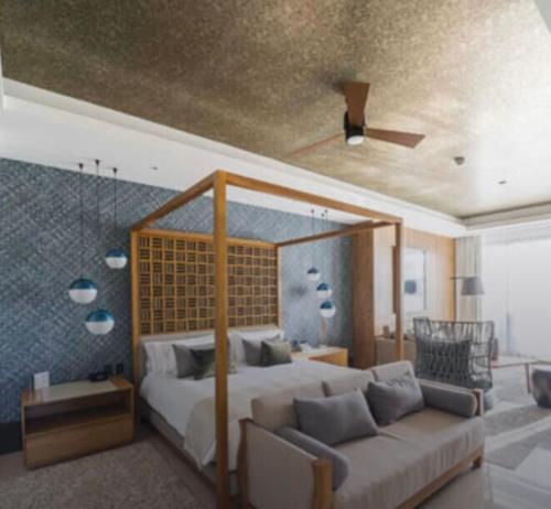 a bedroom with a large bed and a couch at Vidanta Nuevo Vallarta in Nuevo Vallarta 