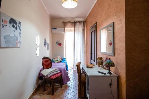 a small room with a bed and a table and chairs at Casa vacanza da Giuseppe in Leonforte