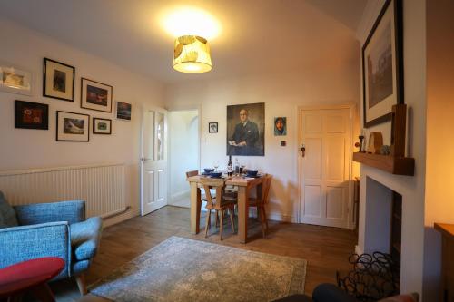 a living room with a table and a dining room at Vibrant 2 Bed, 2 Bath Home, Just Minutes to Town! in Ross on Wye